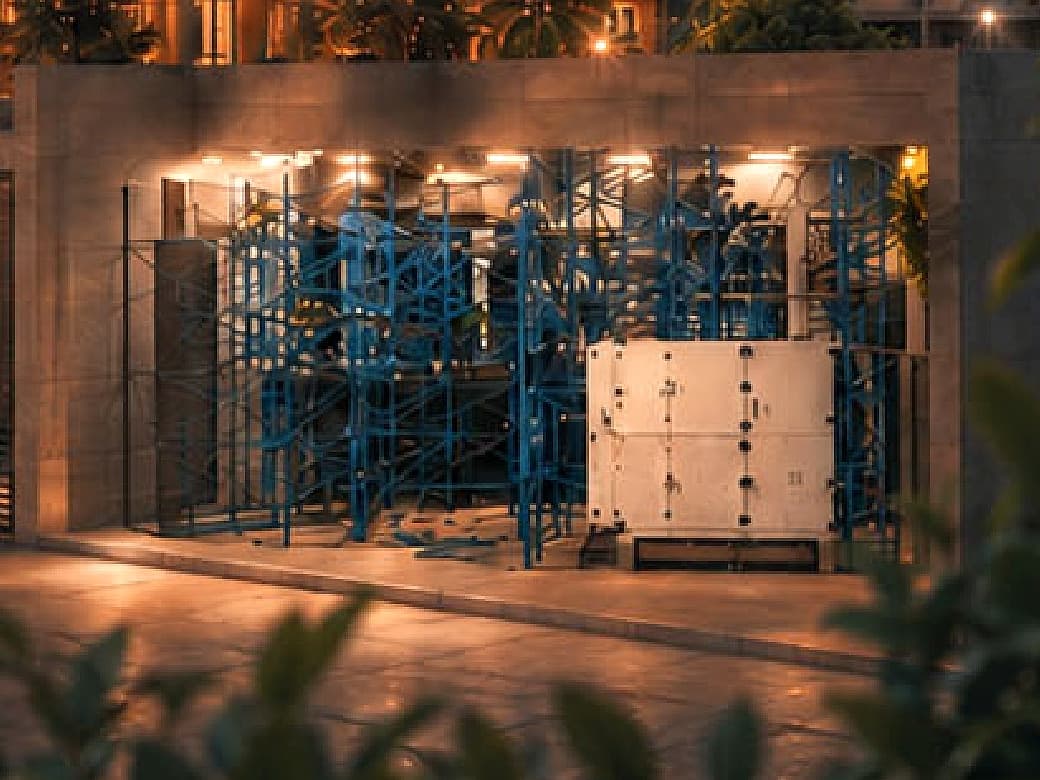 The atmospheric water generation plant — process racking and generator unit lit in its bay